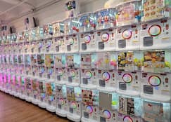 A wall of capsule-toy machines inside the store